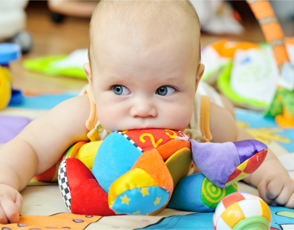 Baby having fun playing with developmental toys