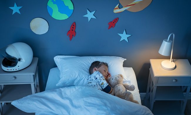 A boy sleeping in his bedroom.