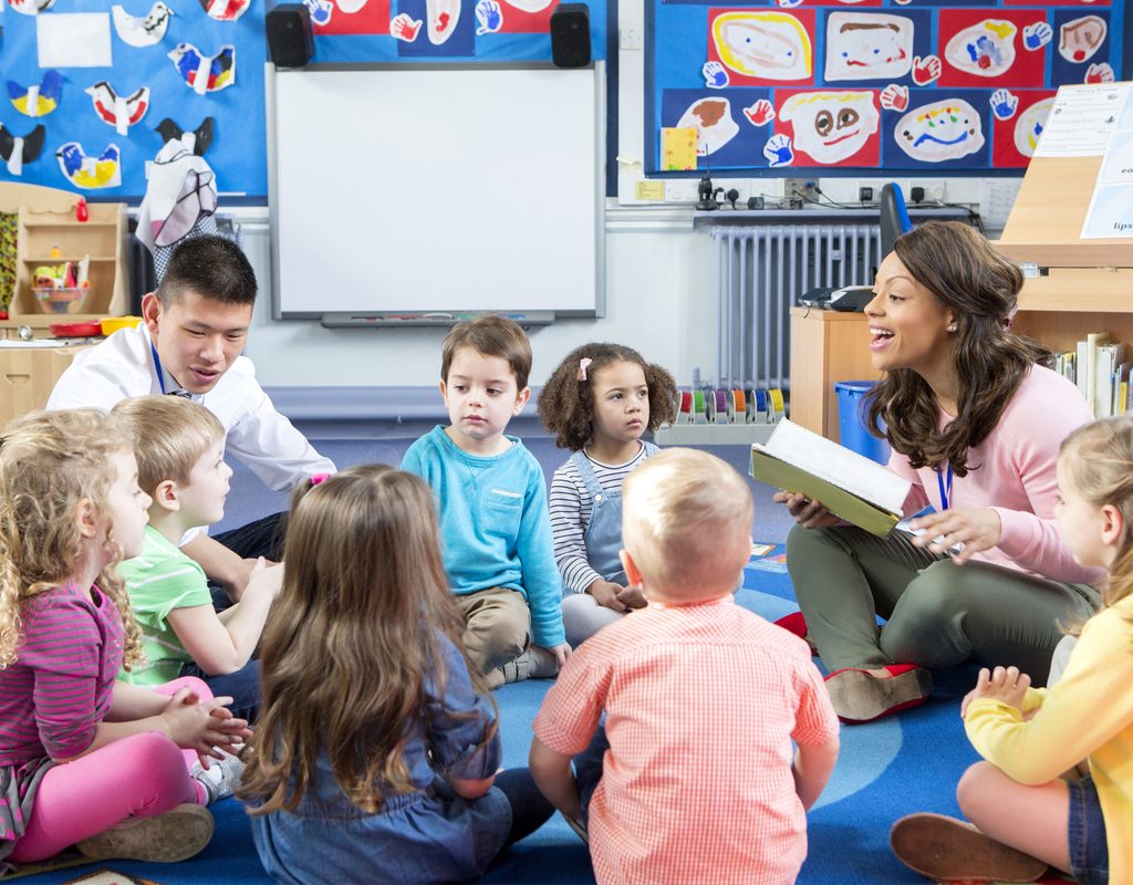 Circle time in a preschool classroom with children and teachers sharing a story
