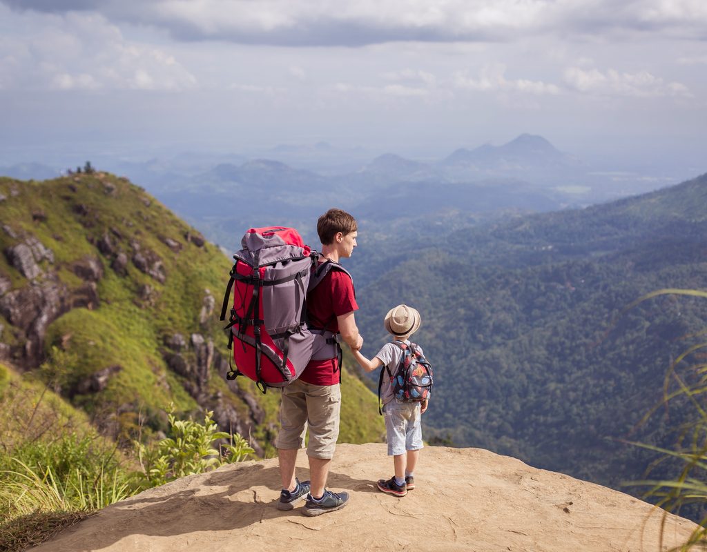 Dad and son enjoy a hike on a mountain