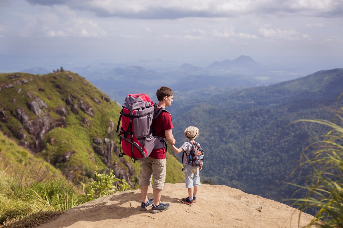 Dad and son enjoy a hike on a mountain