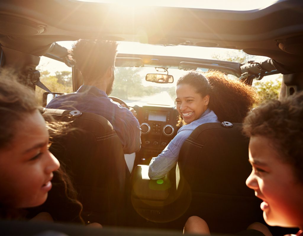 Family enjoying a podcast during a road trip