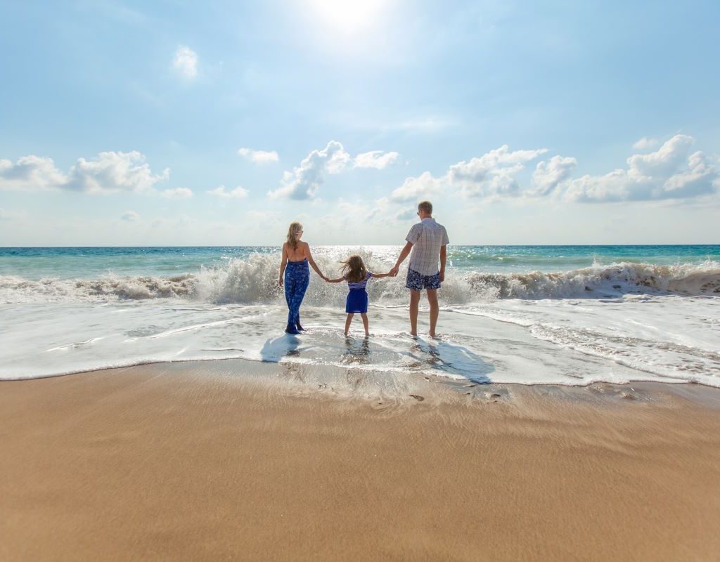 family strolling on the beach