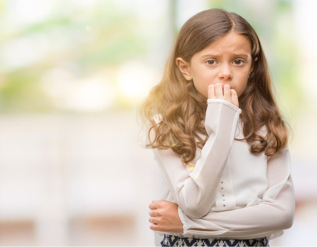 girl nervous biting nails