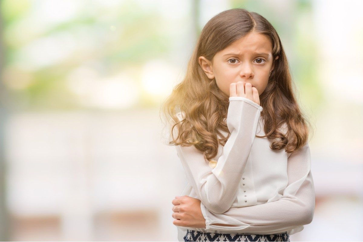A nervous girl biting her nails