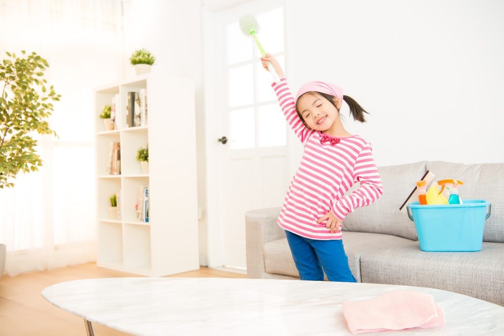 Little girl cleaning her home
