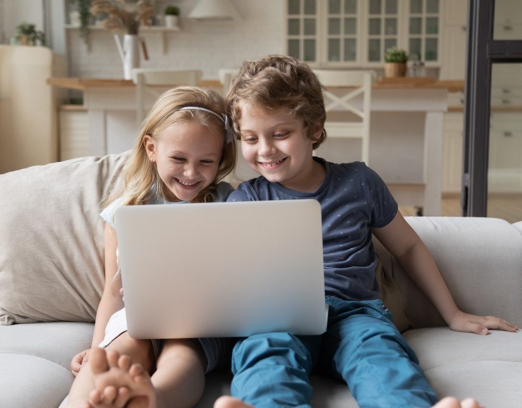 Boy and girl sharing a computer.