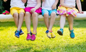 Four kids sitting together outside