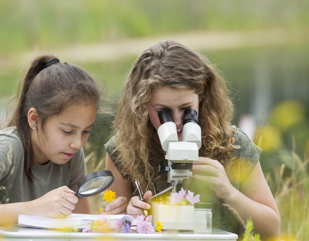 Mom and daughter doing a science experiment together outside