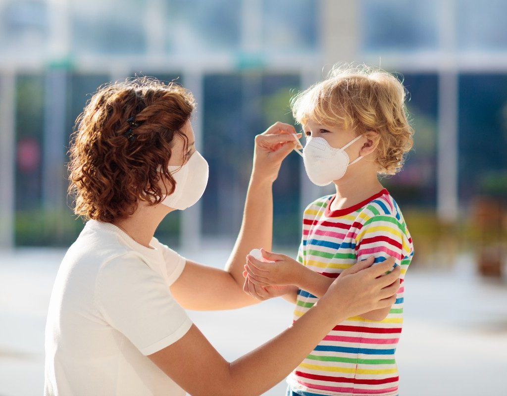 mom putting mask on child