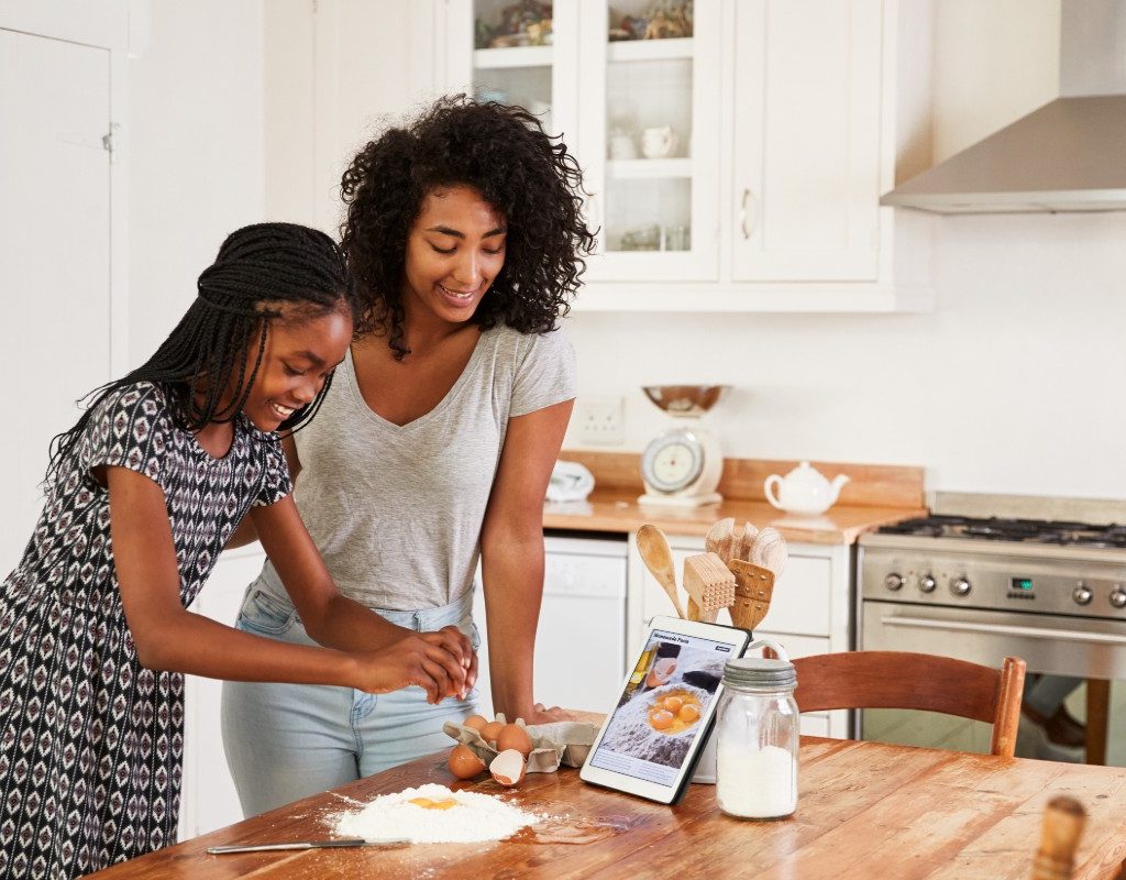 Teen girl and mom baking together
