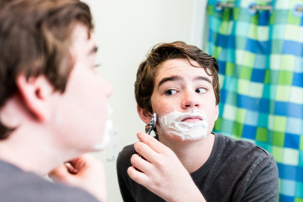 Teen boy shaving
