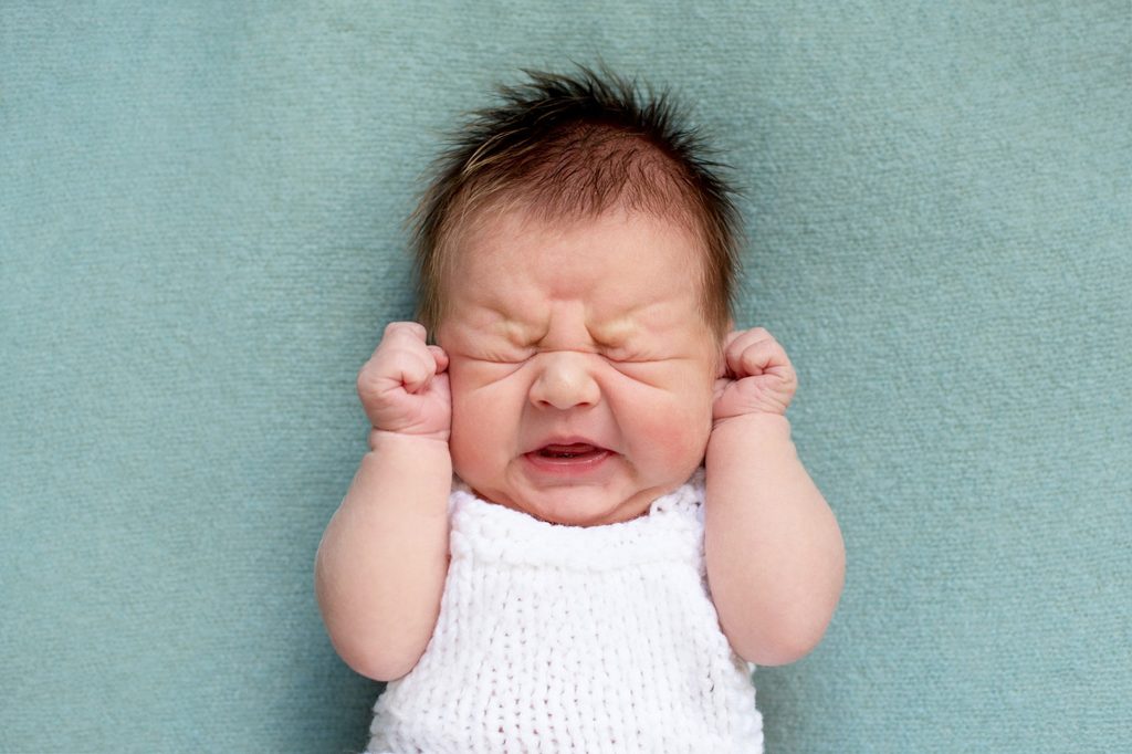 Unhappy newborn crying.