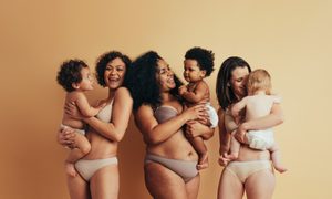 Three women standing together with their babies