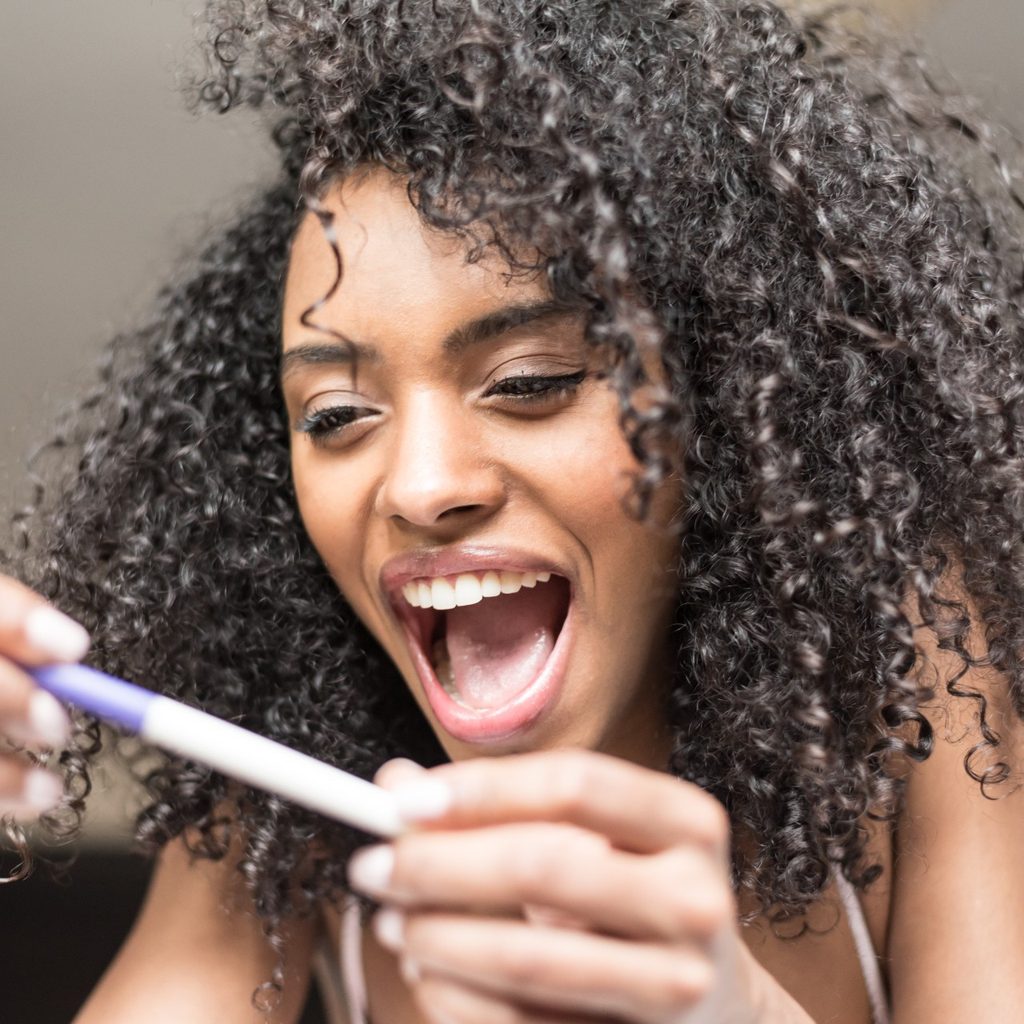 Woman excited at pregnancy test