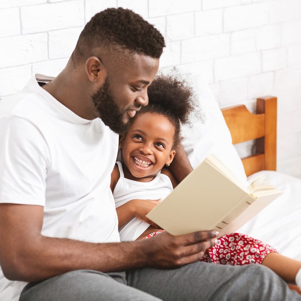 Dad reading to his daughter