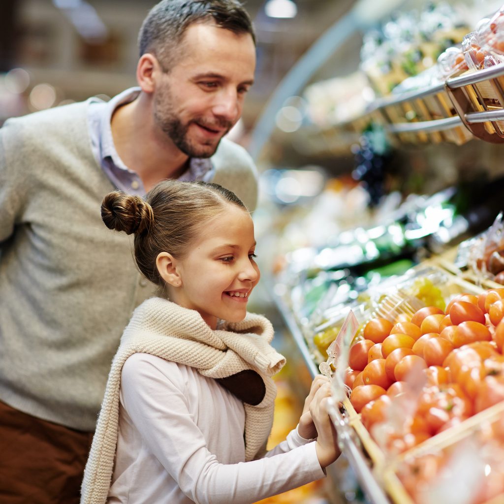 dad and daughter in produce aisle