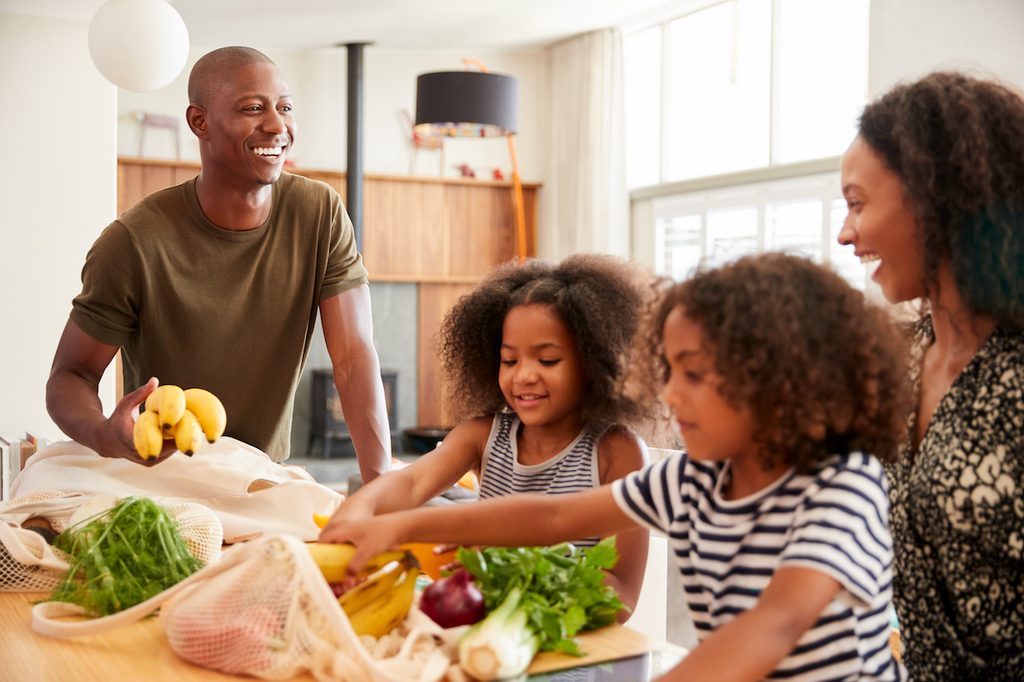 Family unloading groceries at home