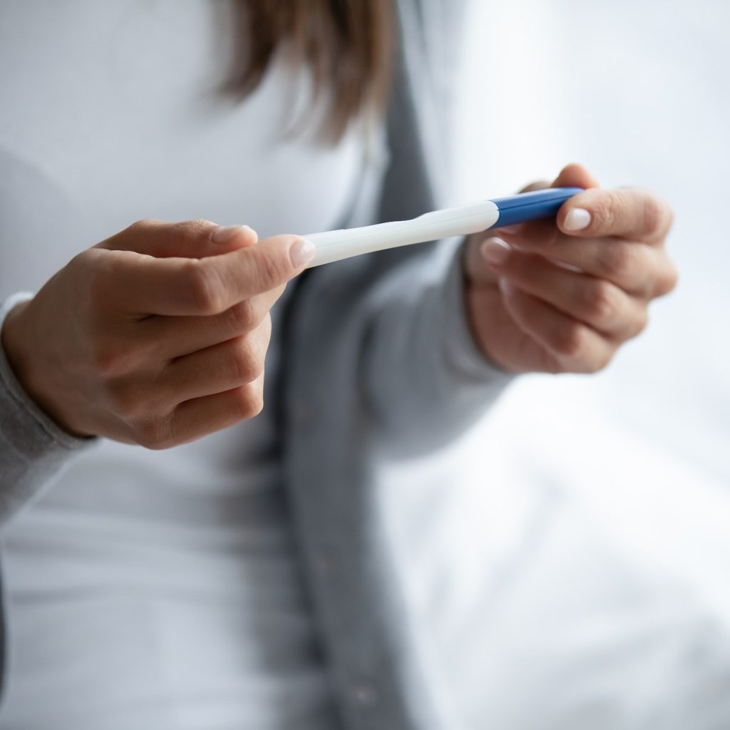 Woman holding a pregnancy test