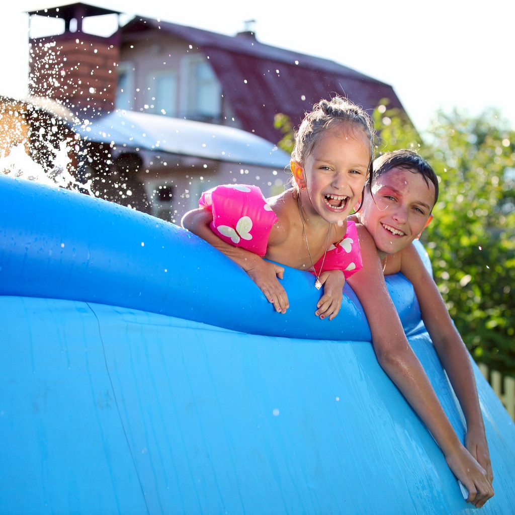 Two siblings in a pool