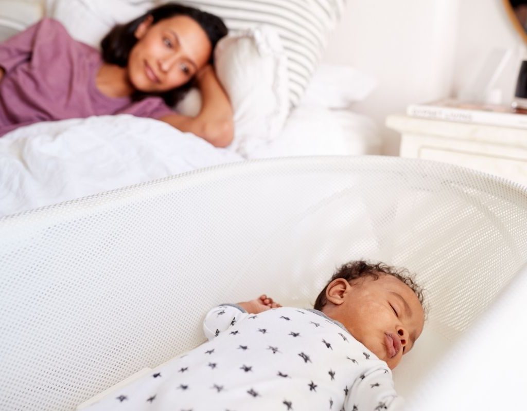 Mom watching sleeping baby.
