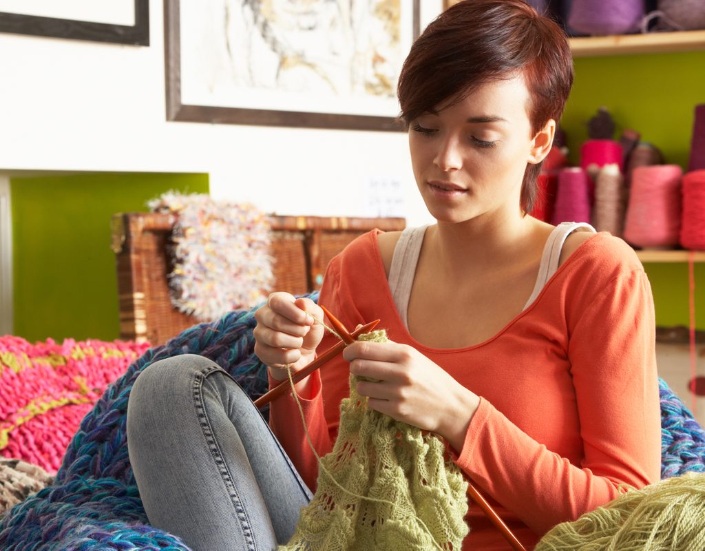 Teen knitting at home