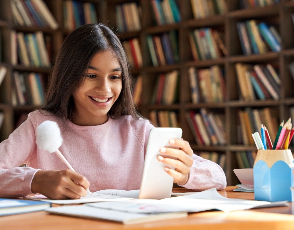 Tween researching on cell phone