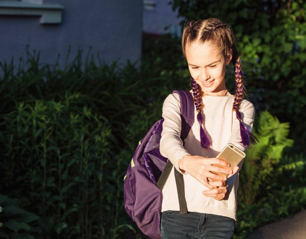 tween taking selfie
