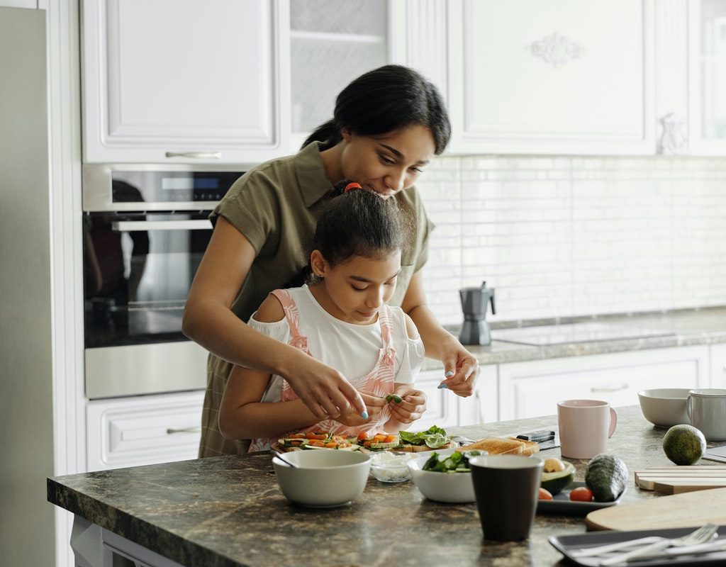 Mom and daughter making avocado toast
