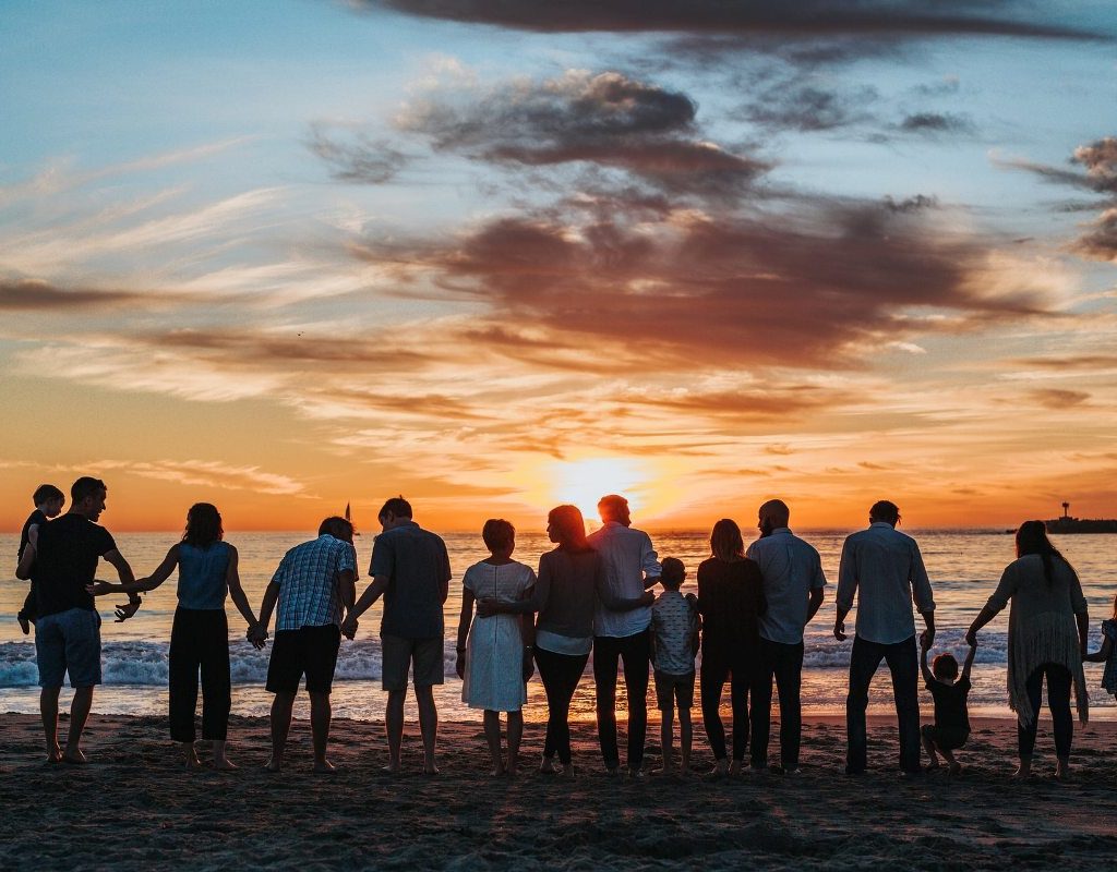 Family reunion on the beach at sunset