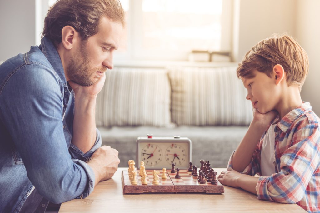 Father and son playing a game of chess
