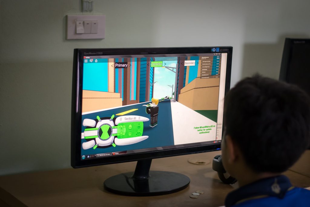 A child playing Roblox on the computer.