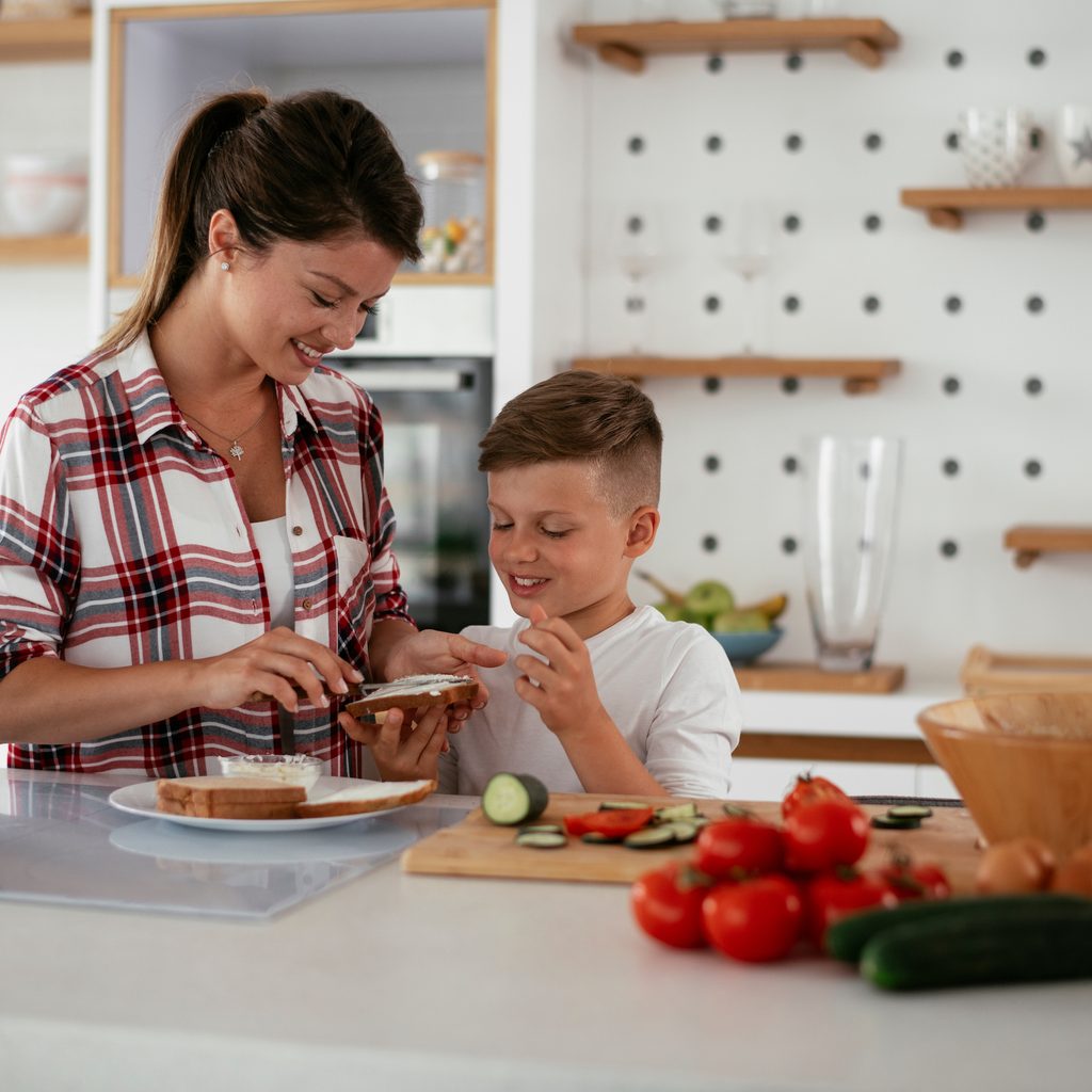 mother and son making dinner