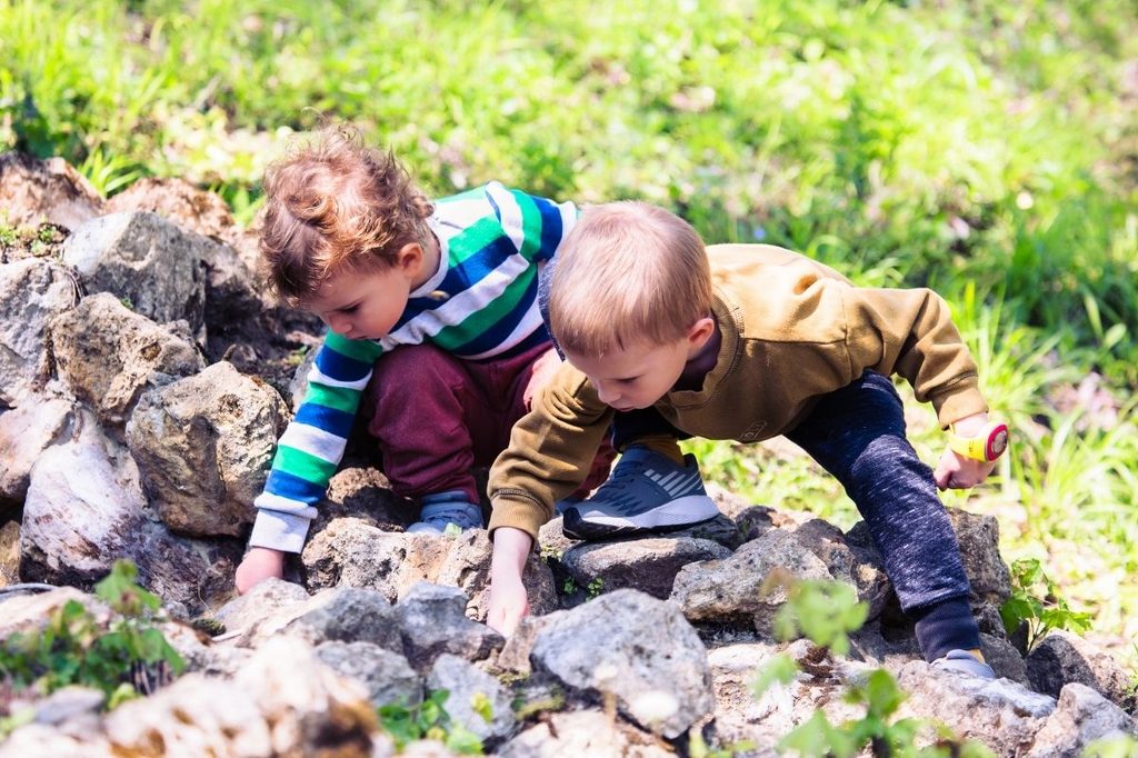 Children playing outside in the grass.