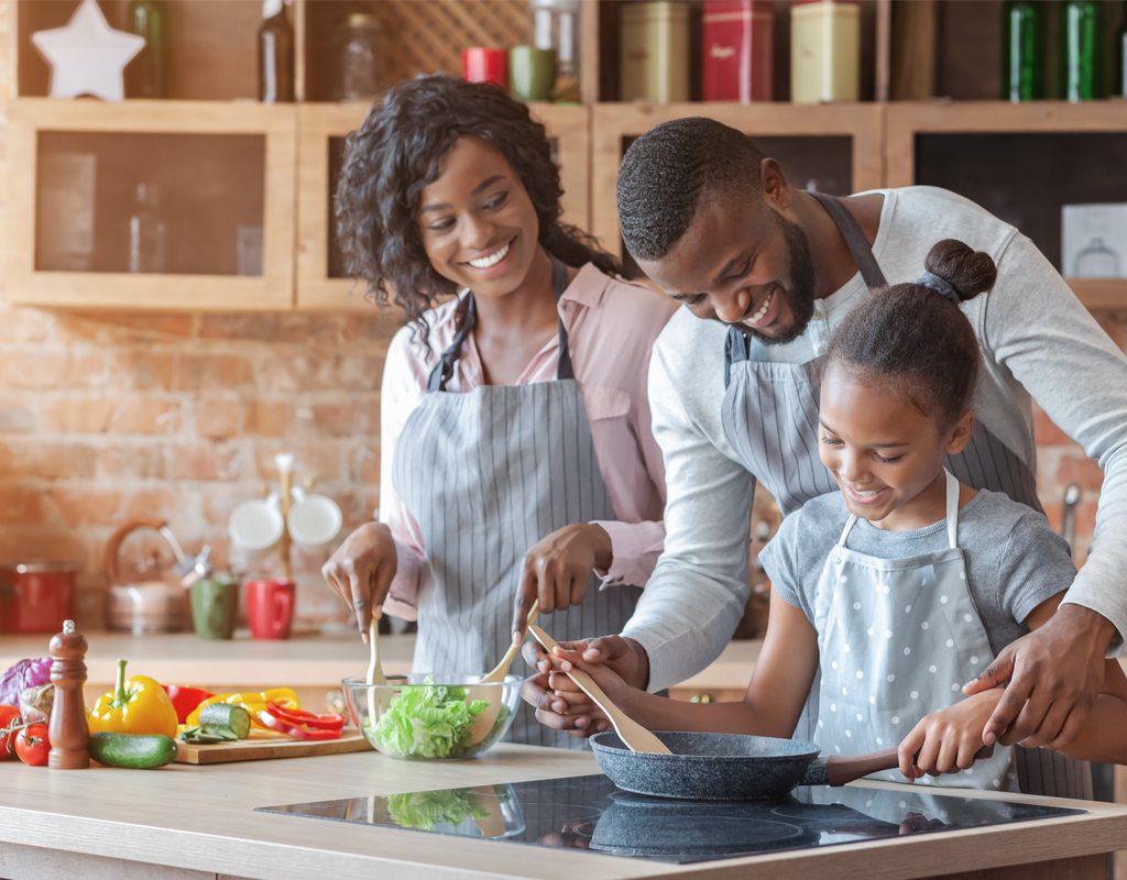 Family of three cooking together