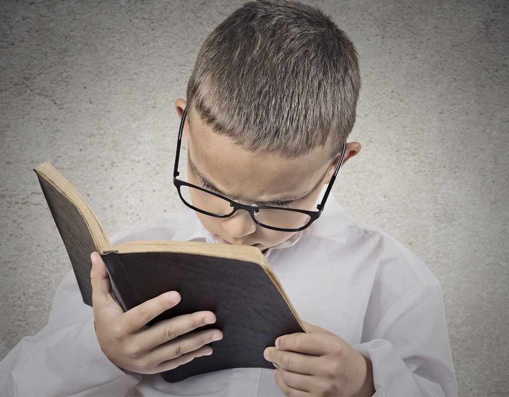 boy having a hard time reading a book