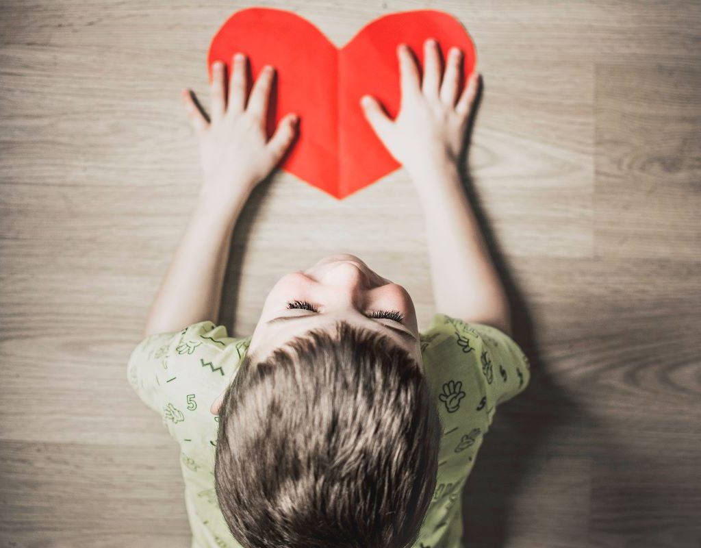 little boy with a paper heart