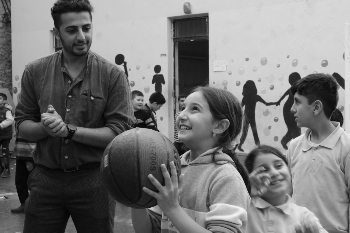 children taking turns with basketball