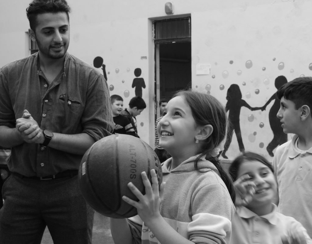 children taking turns with basketball