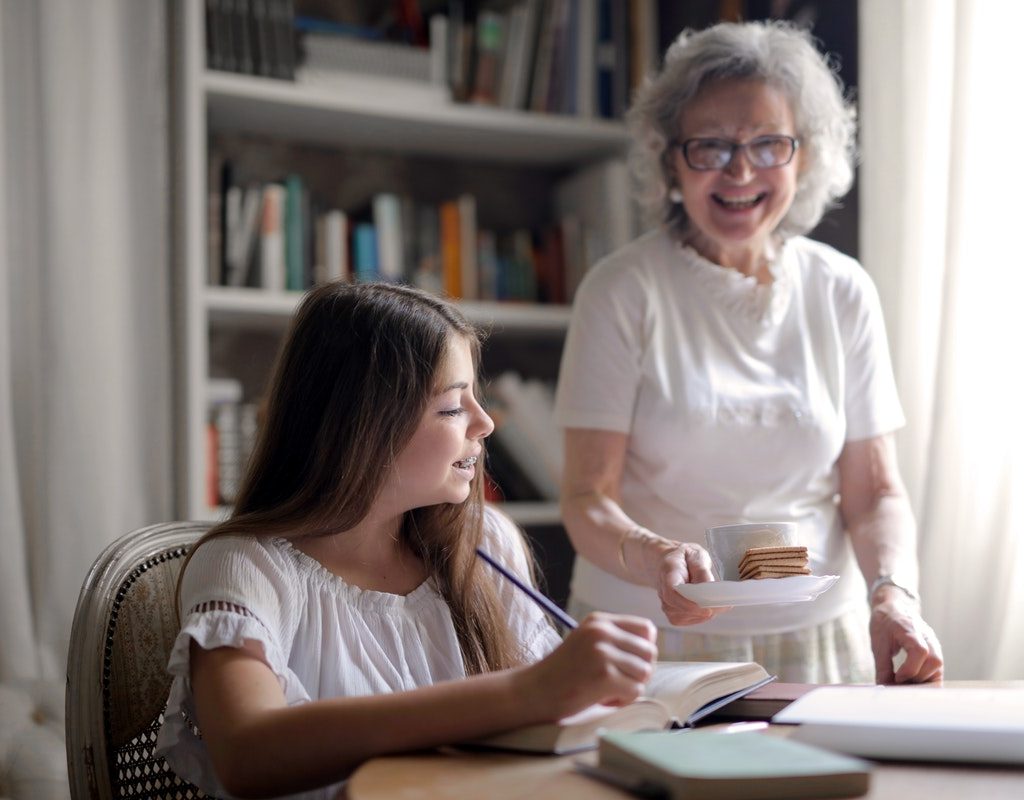 grandmother bringing snack to teen