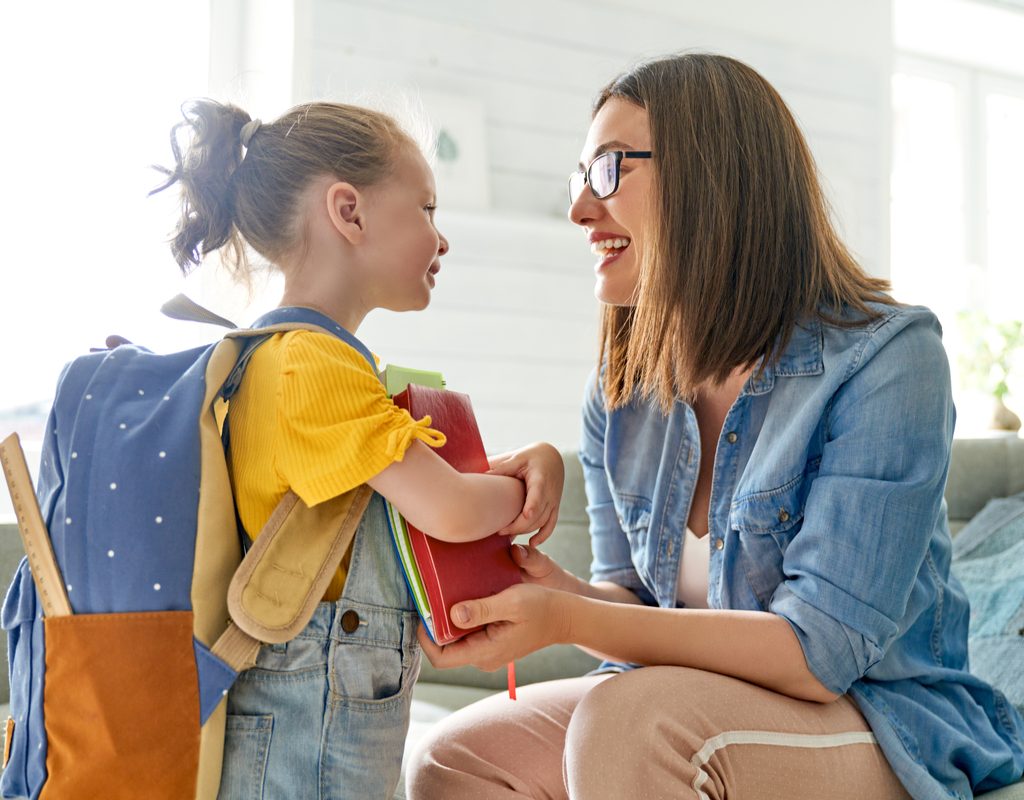 A mom and child getting ready to go to school.
