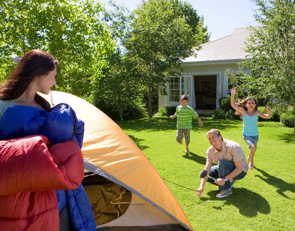 A family camping out in their backyard.