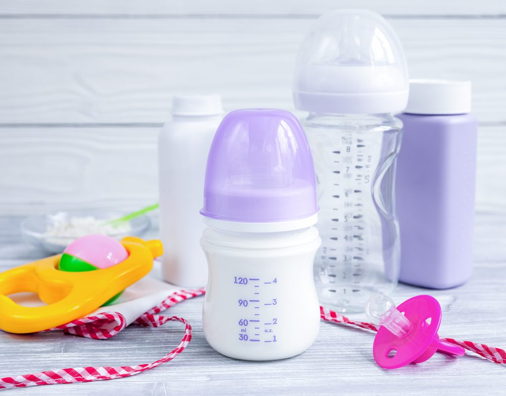 A few baby bottles on a table.