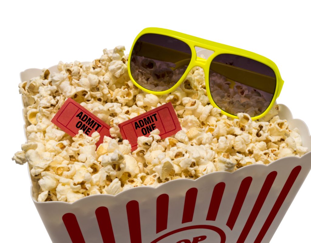 Popcorn with sunglasses and movie tickets