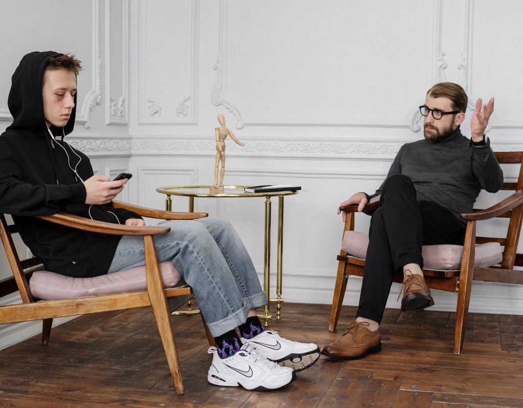 teenage boy talking to an adult