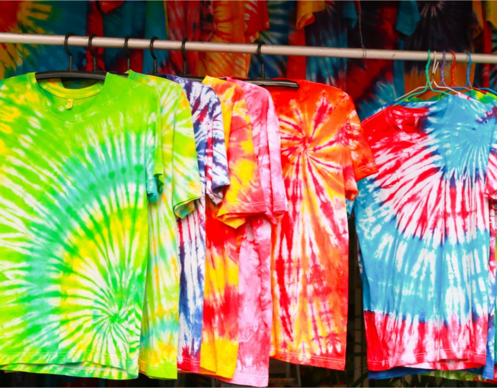 Colorful tie-dye shirts hanging on a line.