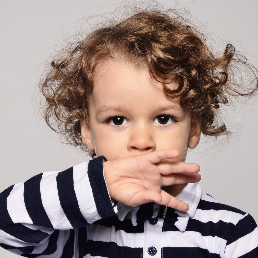 Toddler sucking on back of their hand.
