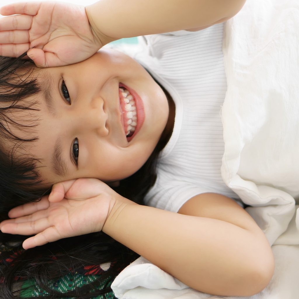 Toddler playing peekaboo.
