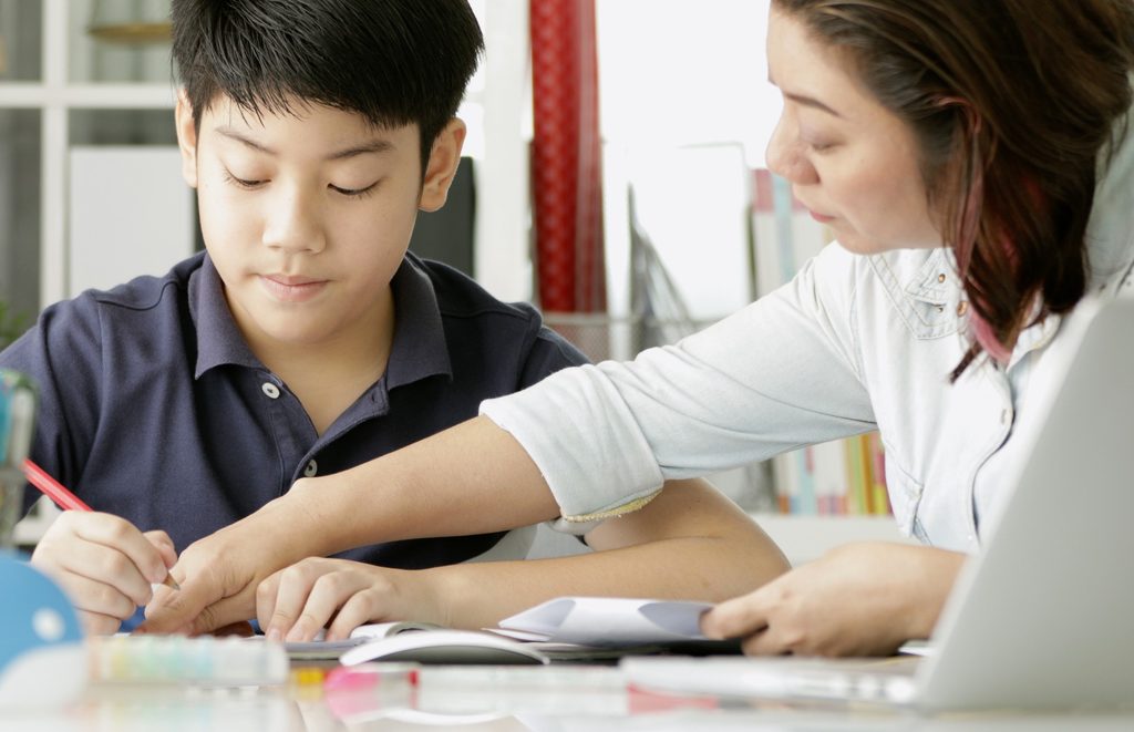 Mom and teen boy doing homework