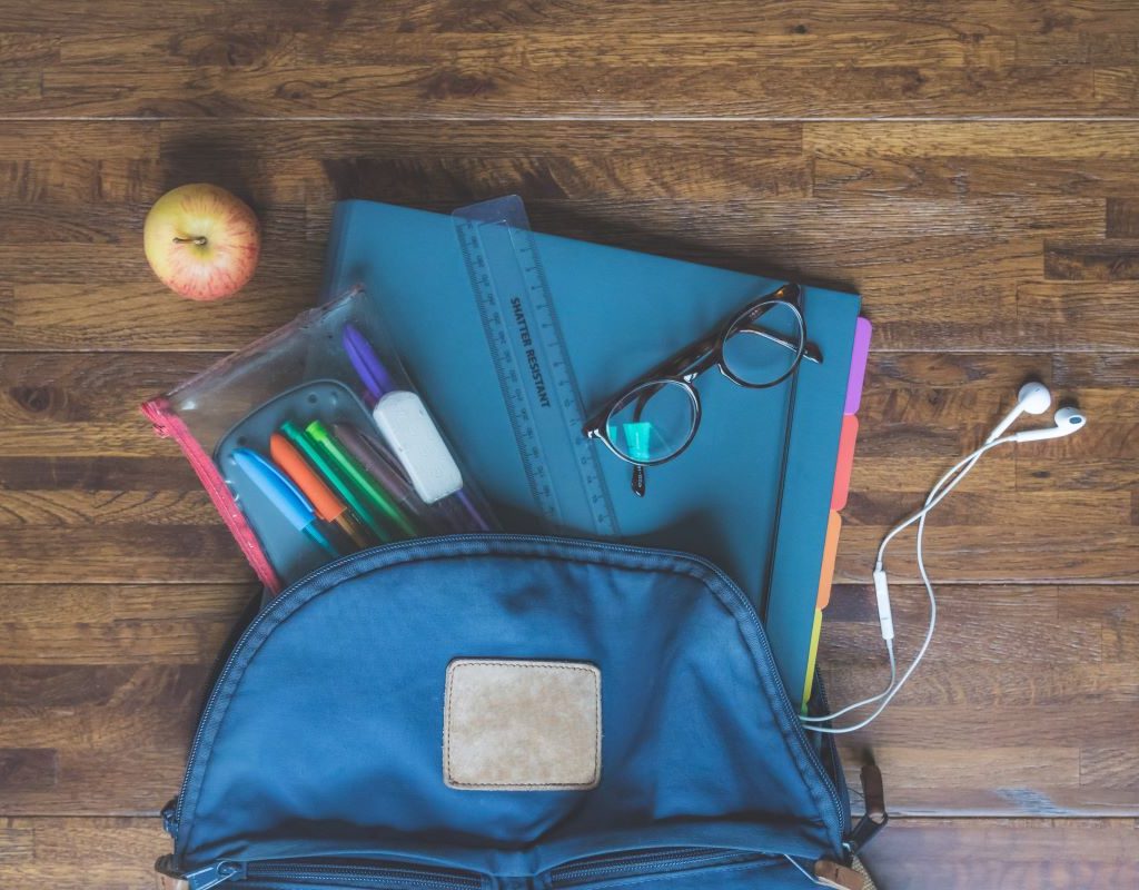blue backpack with school supplies